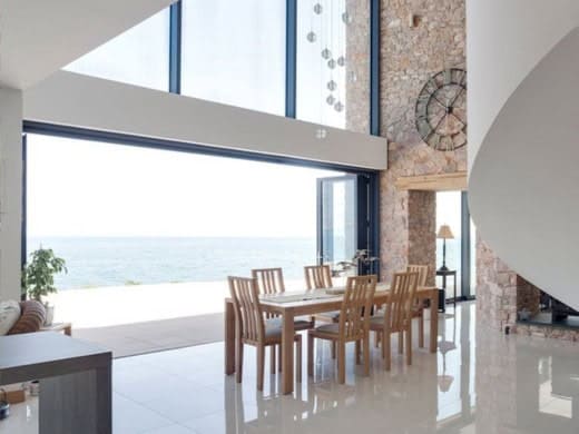 Open aluminium bi-fold doors Cromer with views of the sea - Wymondham Windows